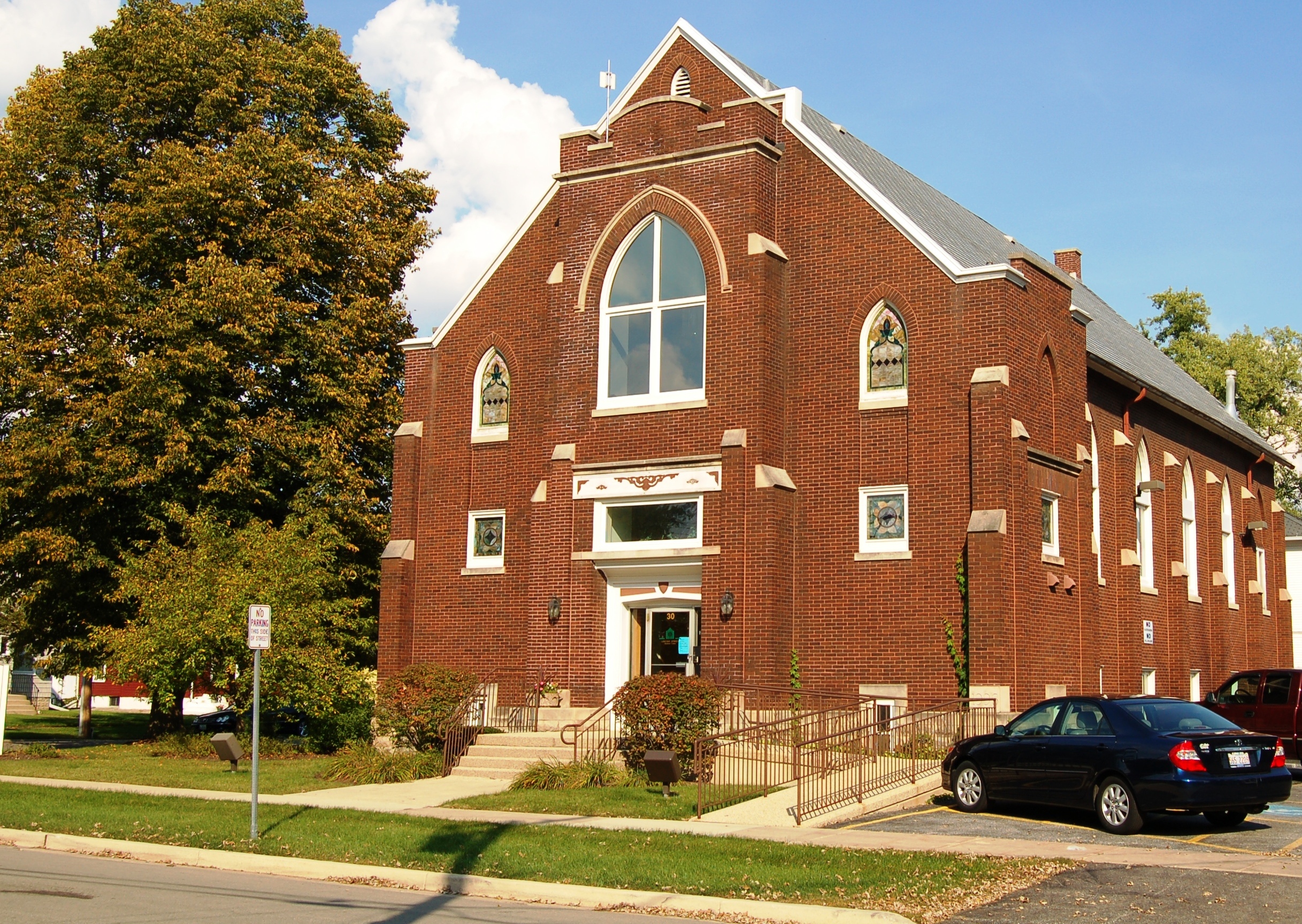 Brick church with stained glass windows.