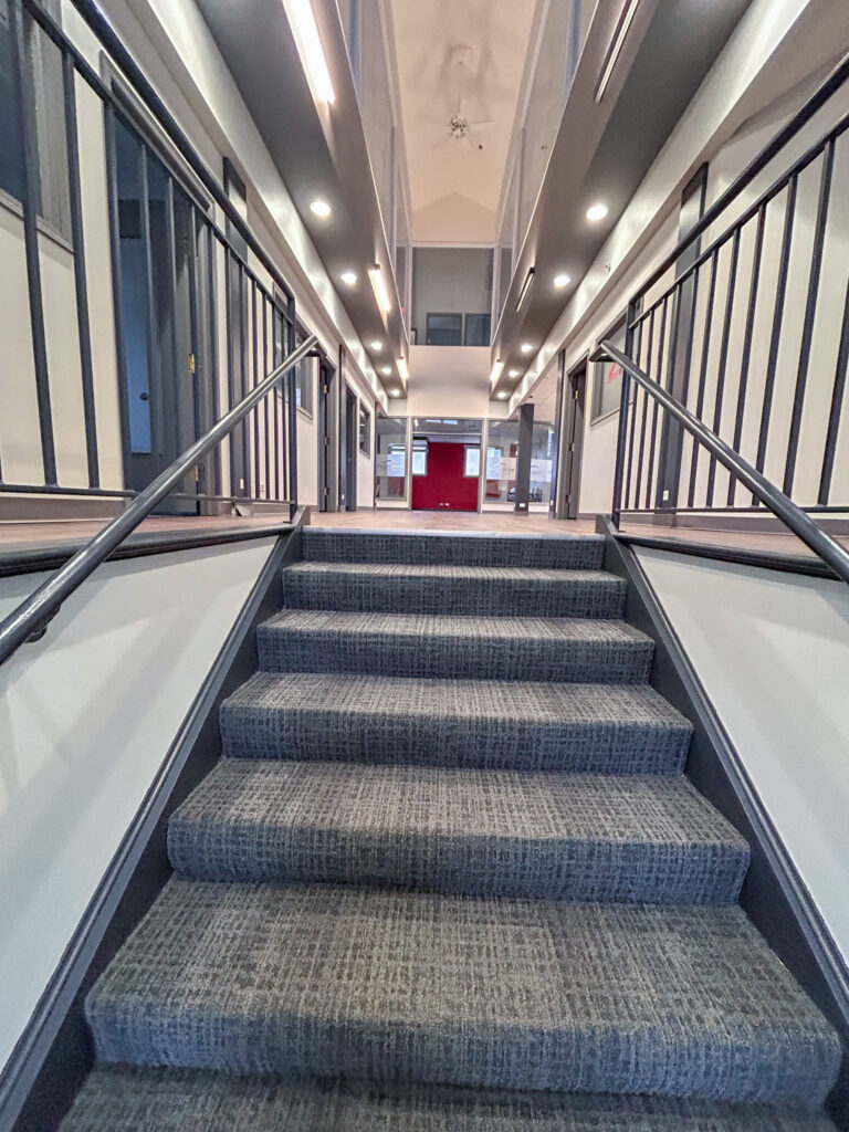Carpeted staircase in modern office building